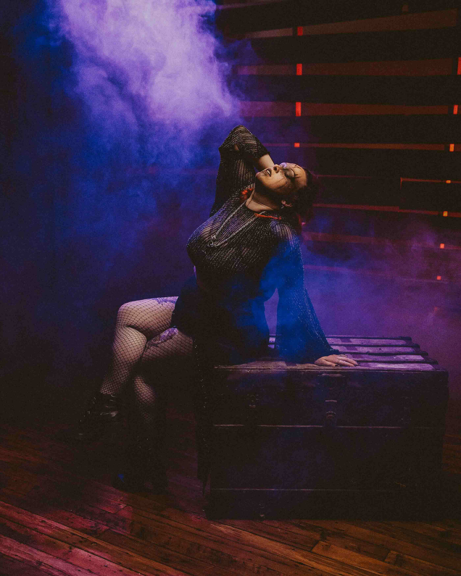 spooky woman sitting on a box with smoke effect