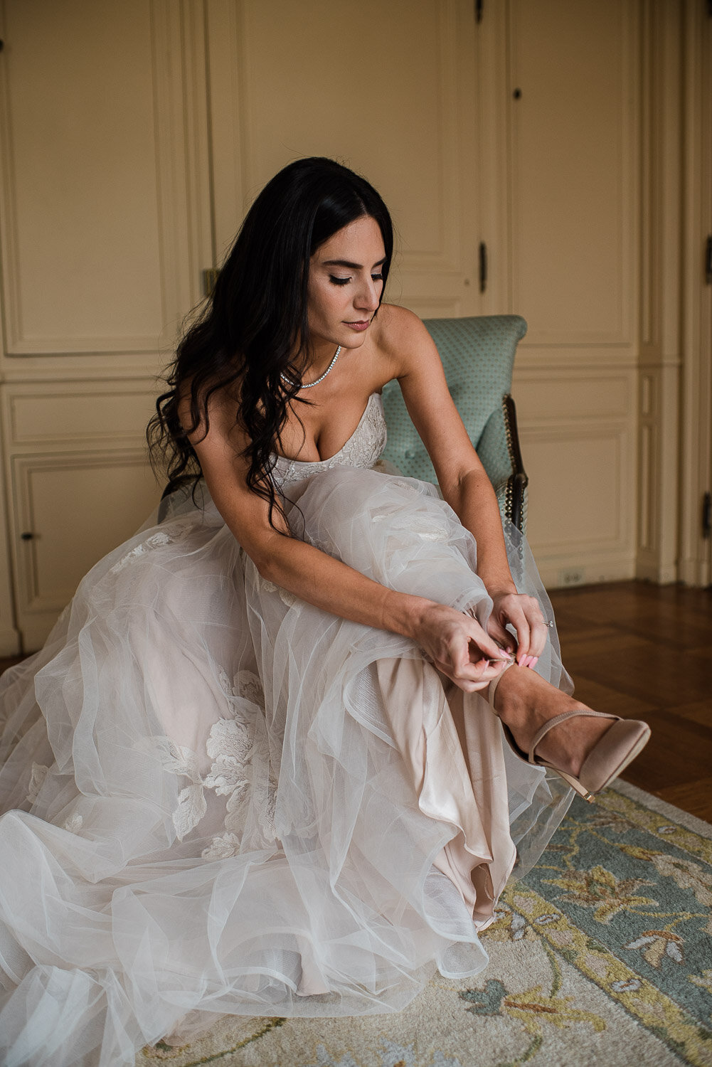 bride adjusting shoe getting ready