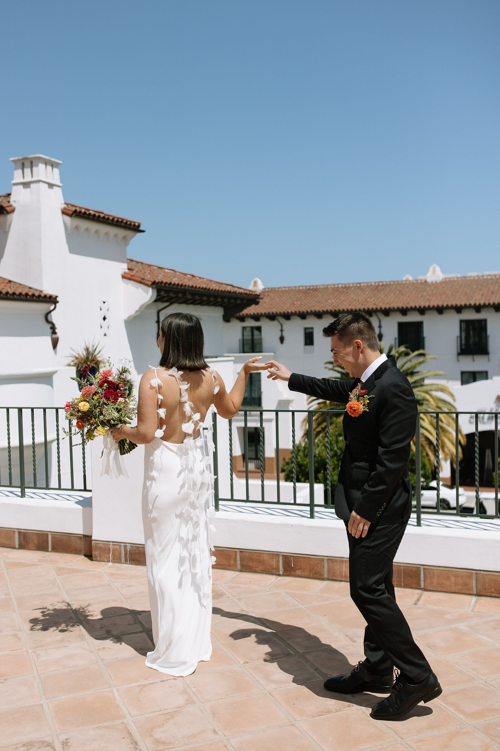 Bride and groom sharing a first look outside Santa Barbara Courthouse wedding