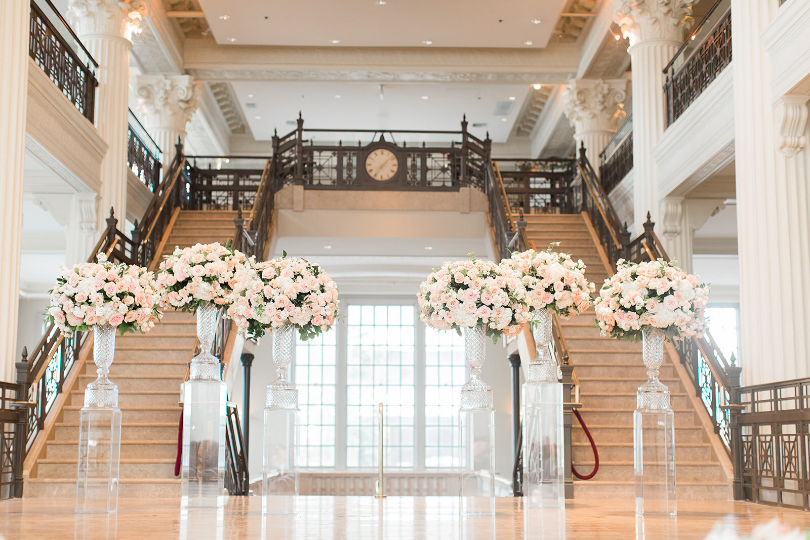 indoor wedding ceremony with grand staircase in the background