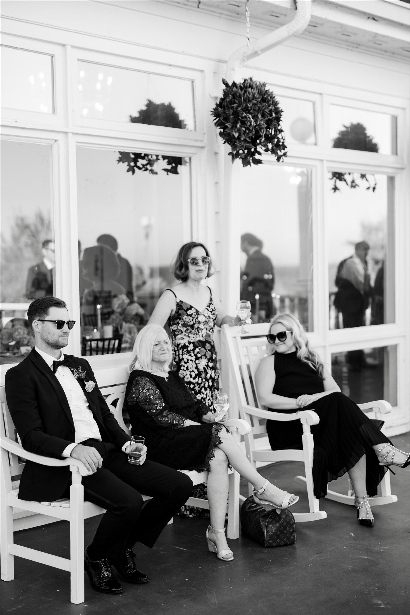 Wedding guests sitting on the Mission Point Resort Porch