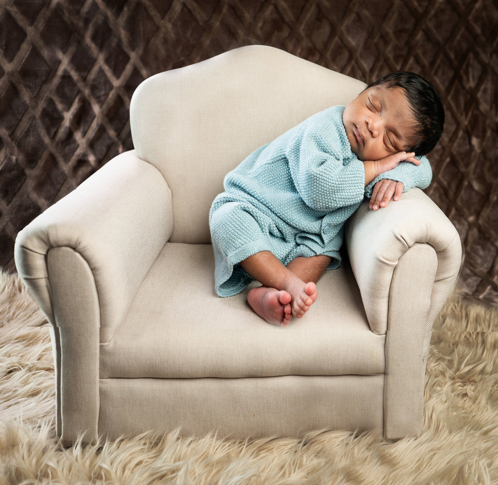 newborn sitting in chair
