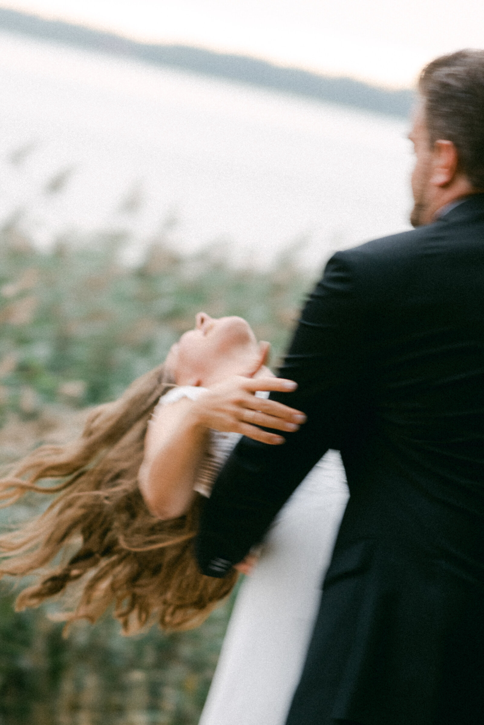The groom is bending the bride while dancing during their wedding photo shoot with elopement photographer Hannika Gabrielsson.
