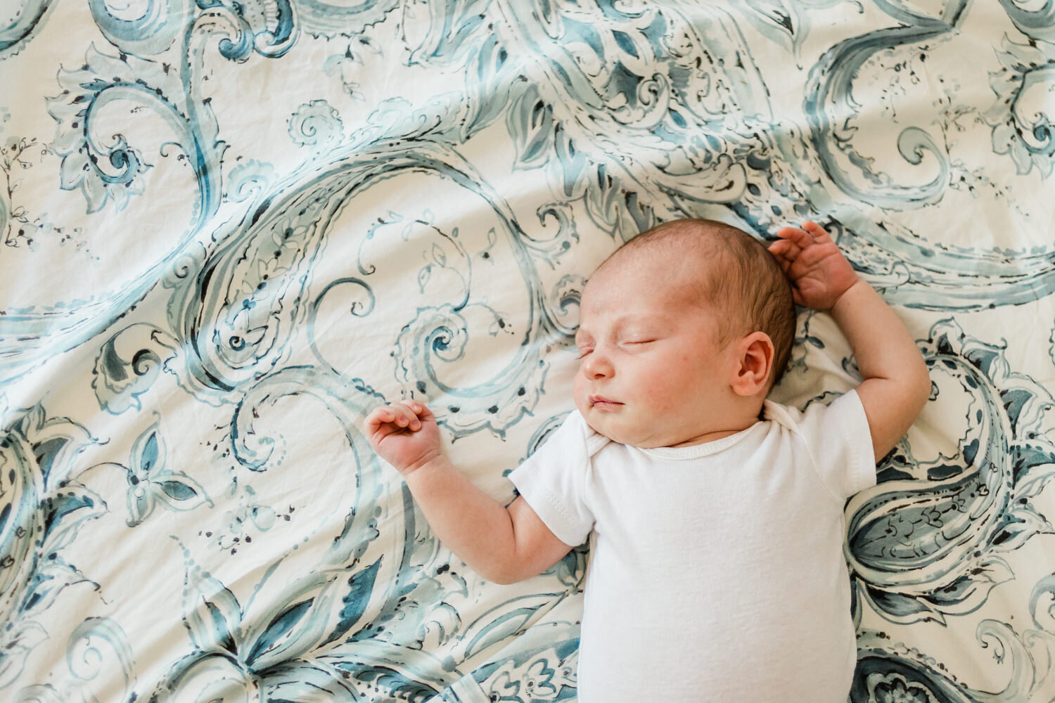 Newborn baby sleeping on bed