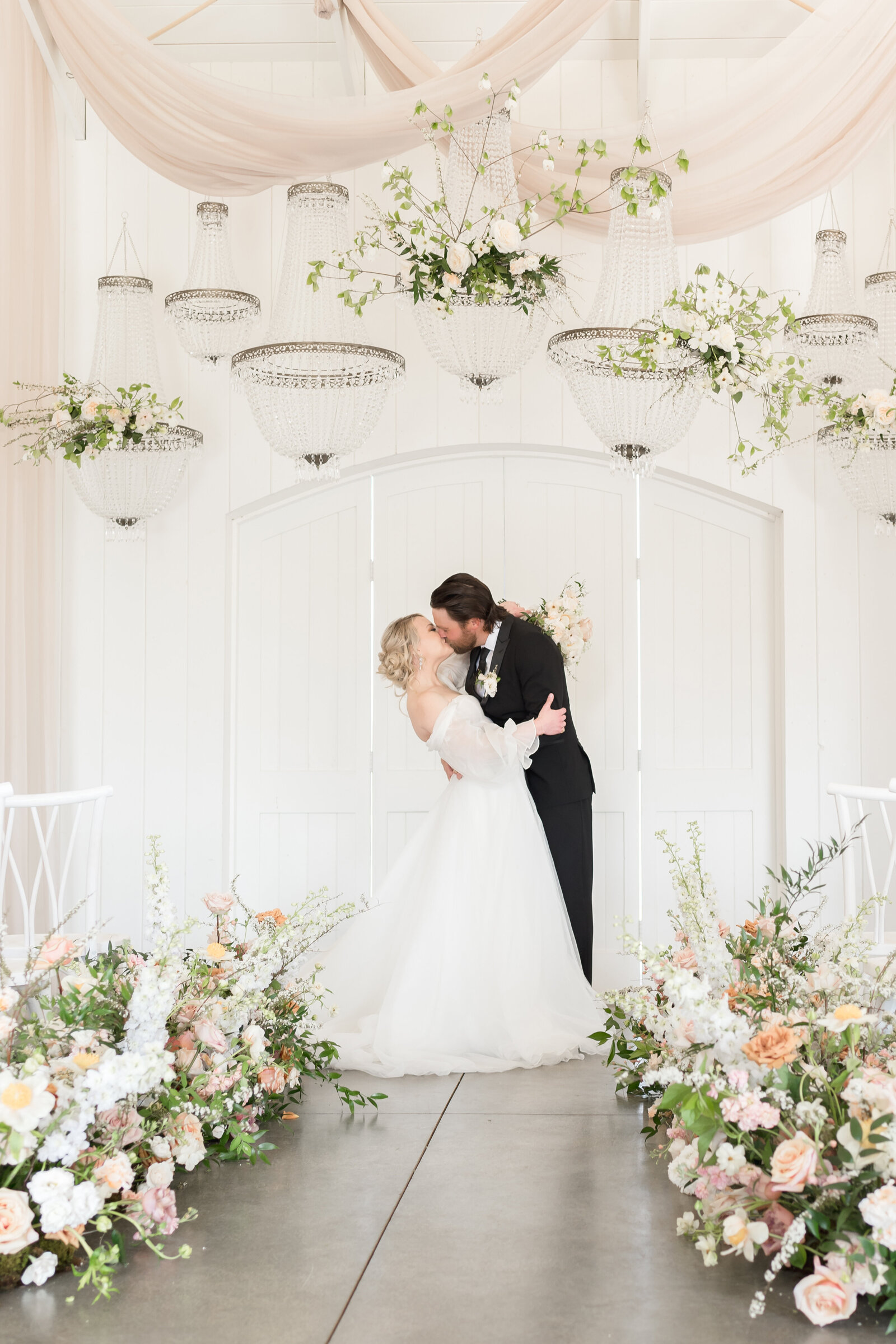 couple standing in aisle kissing