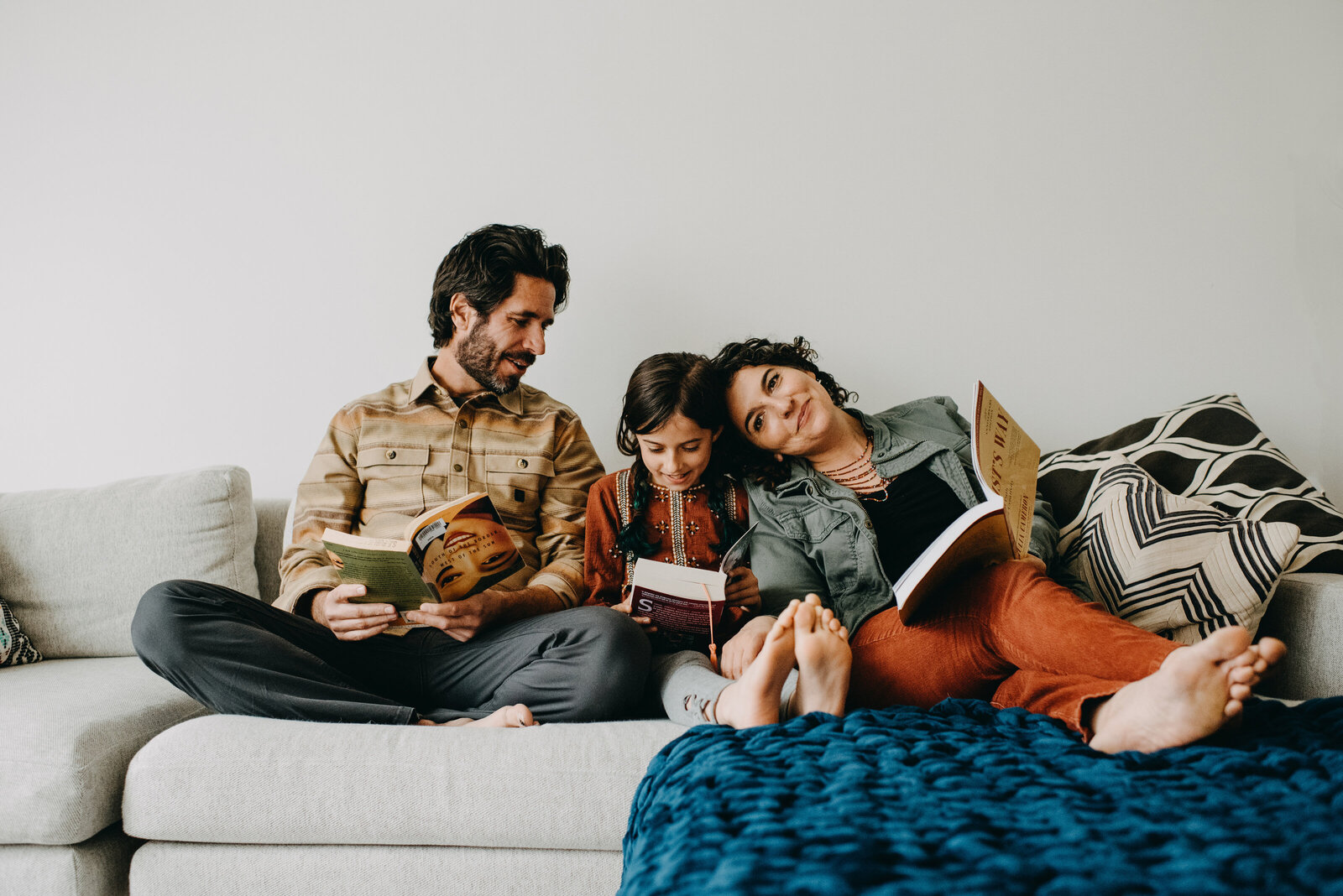 San Francisco family reads together on couch at home lifestyle portrait