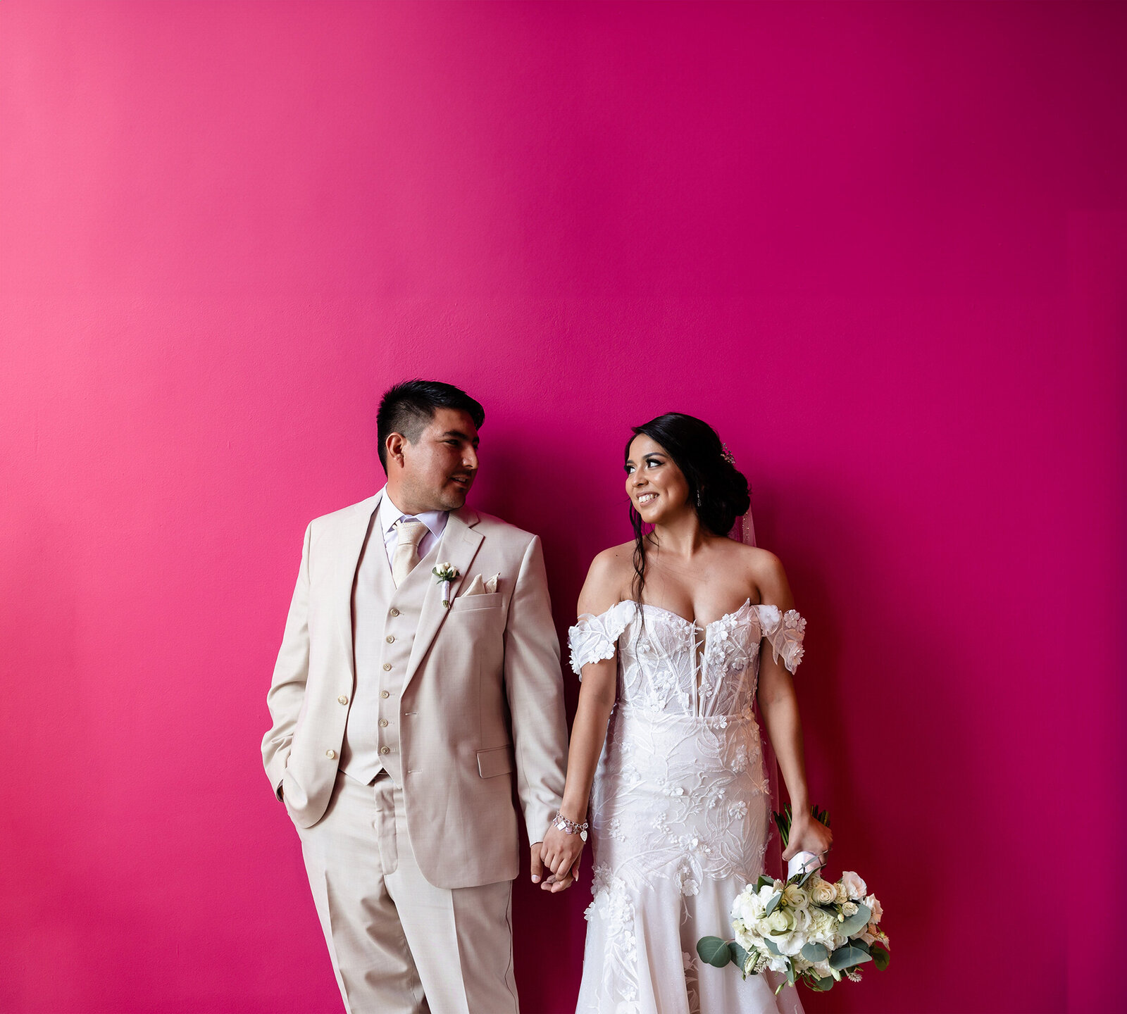 beautiful-bride-and-groom-pink-background