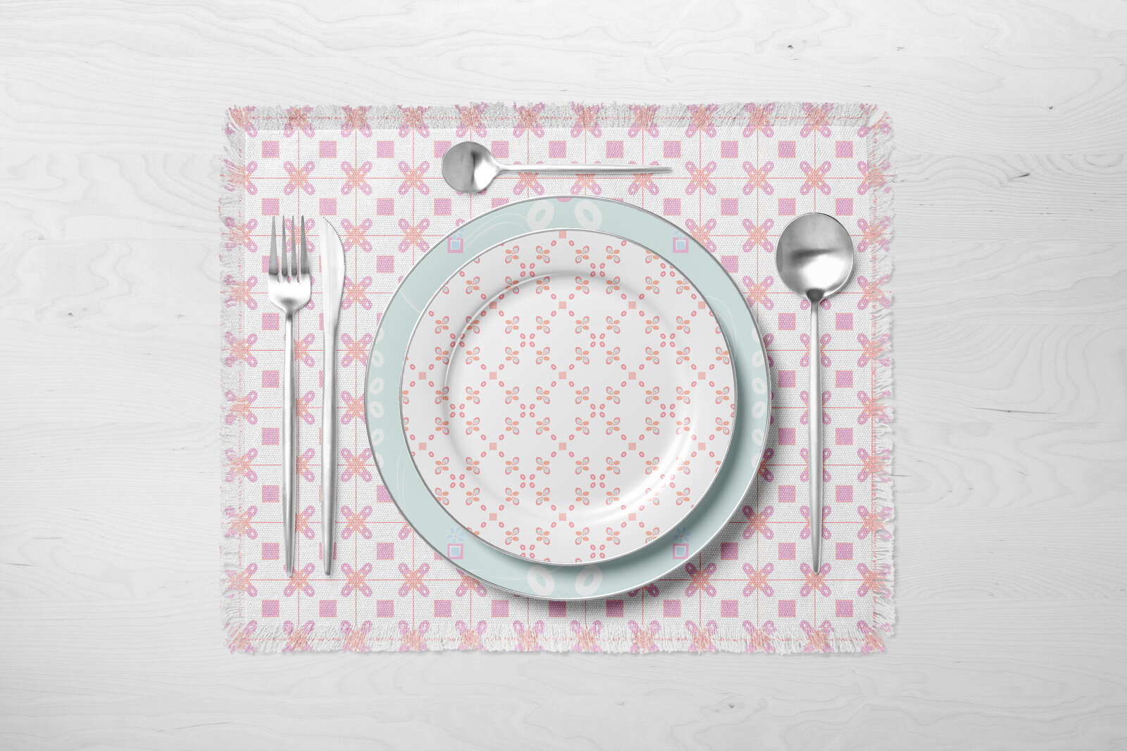 pink and white patterned placemat with patterned dishes