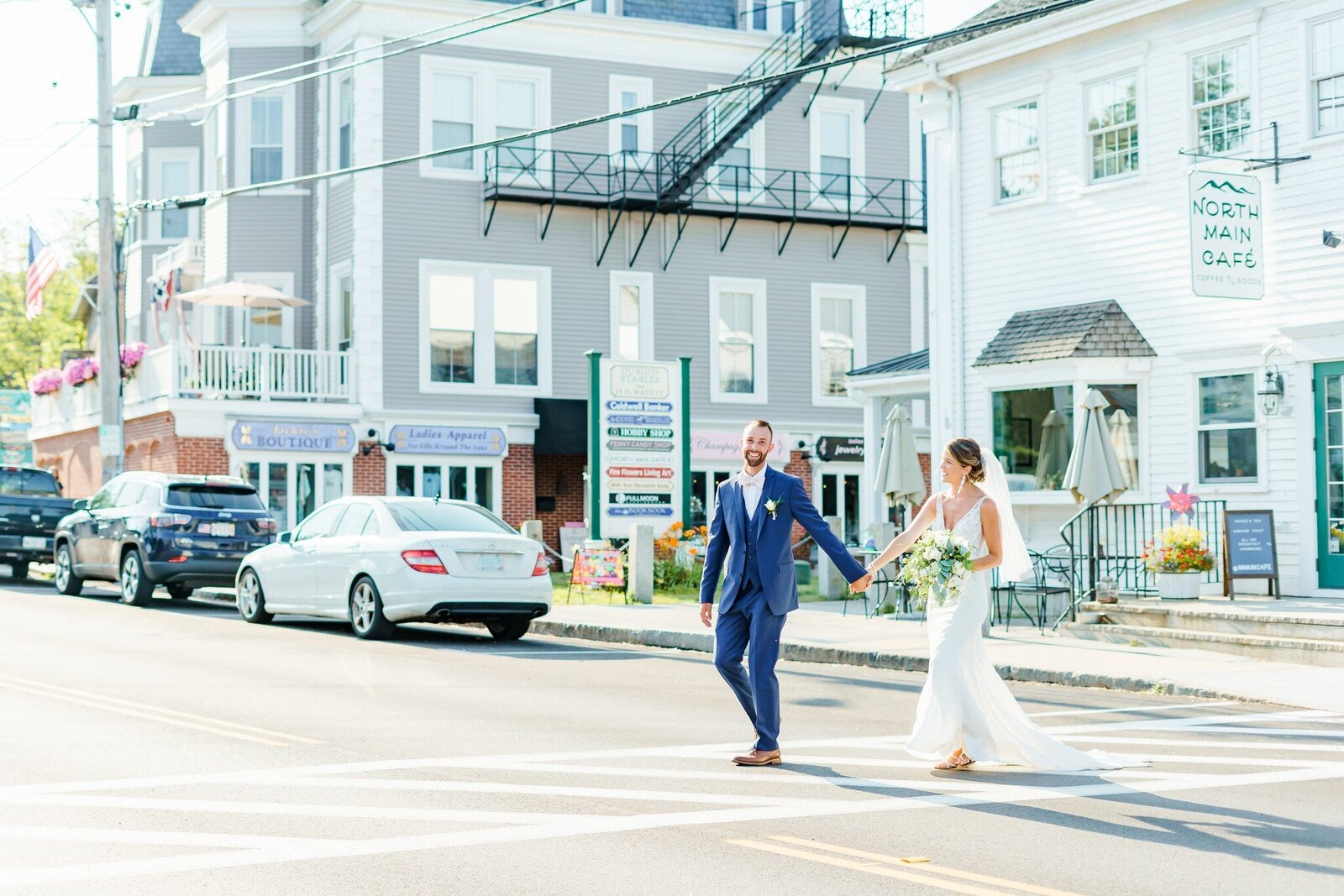 Bride and groom crossing the street holding hand for wedding photos