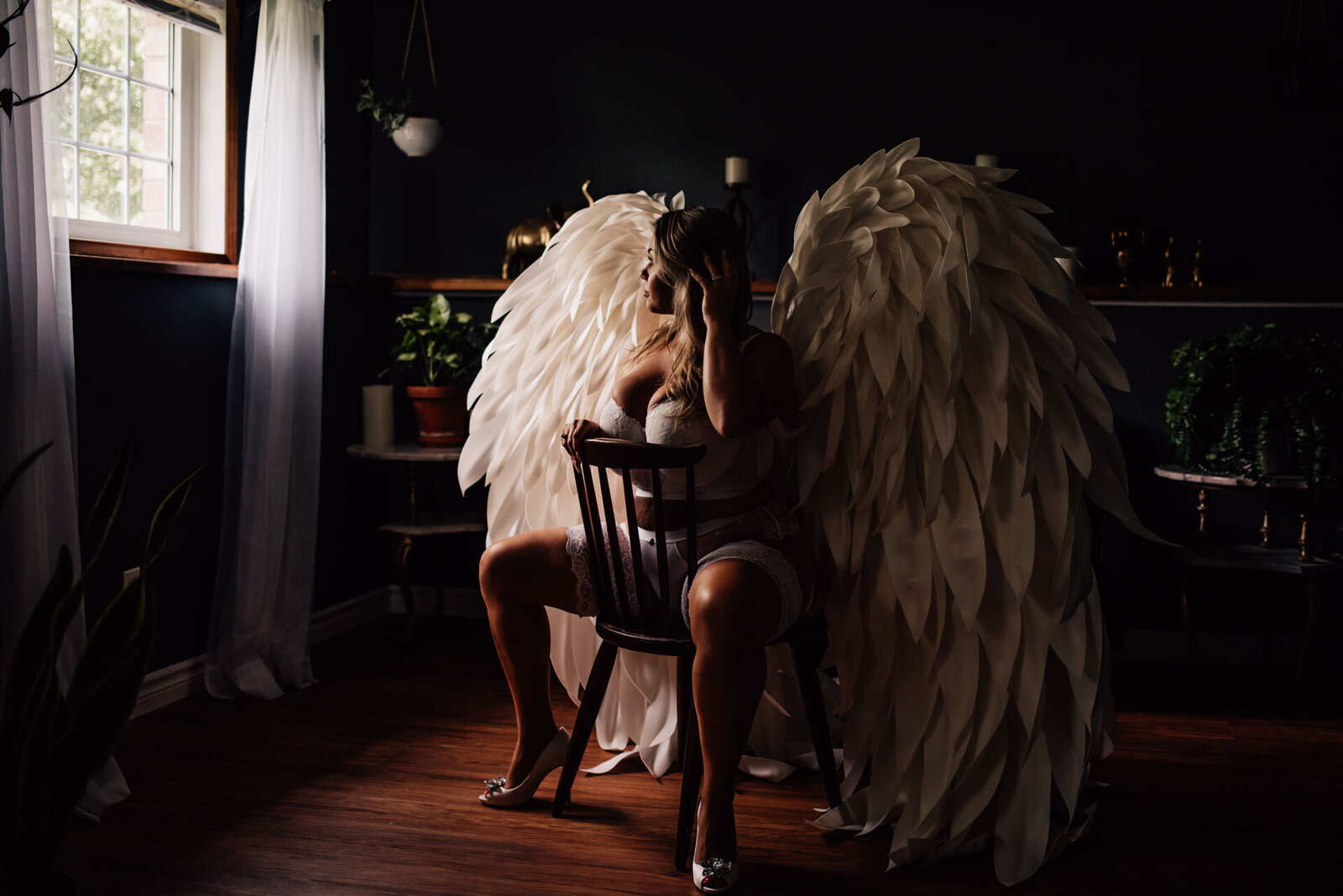 woman wearing angel wings for studio boudoir session in ottawa