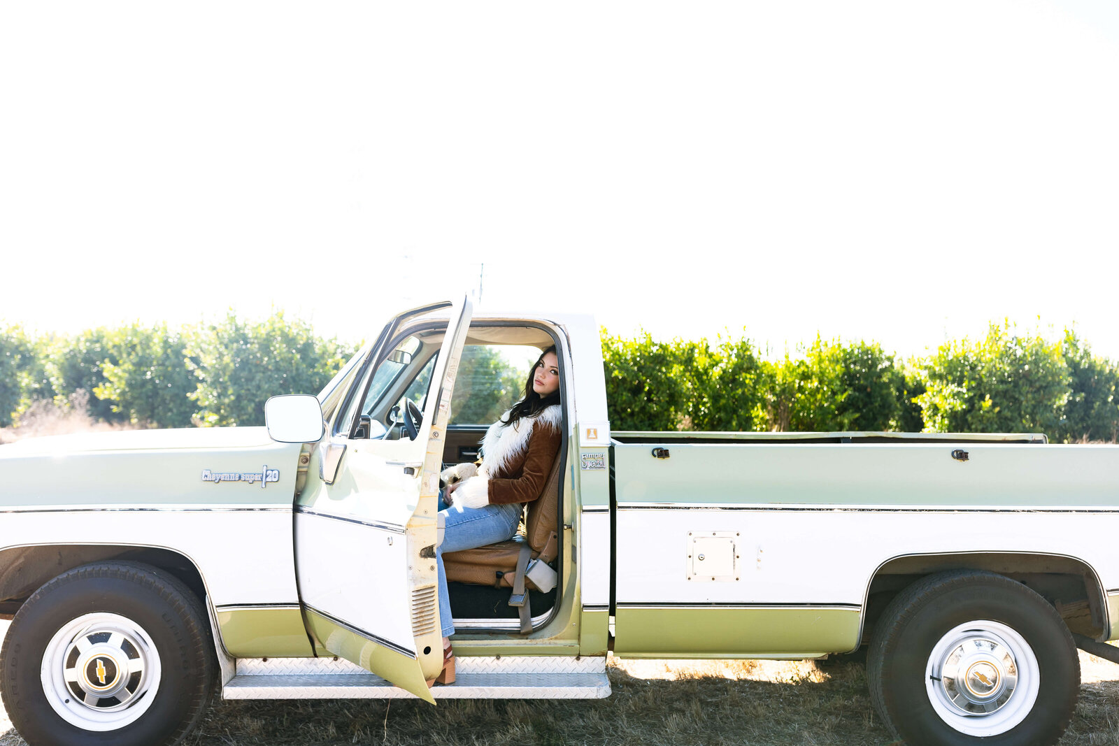 girl sitting in an old vintage truck