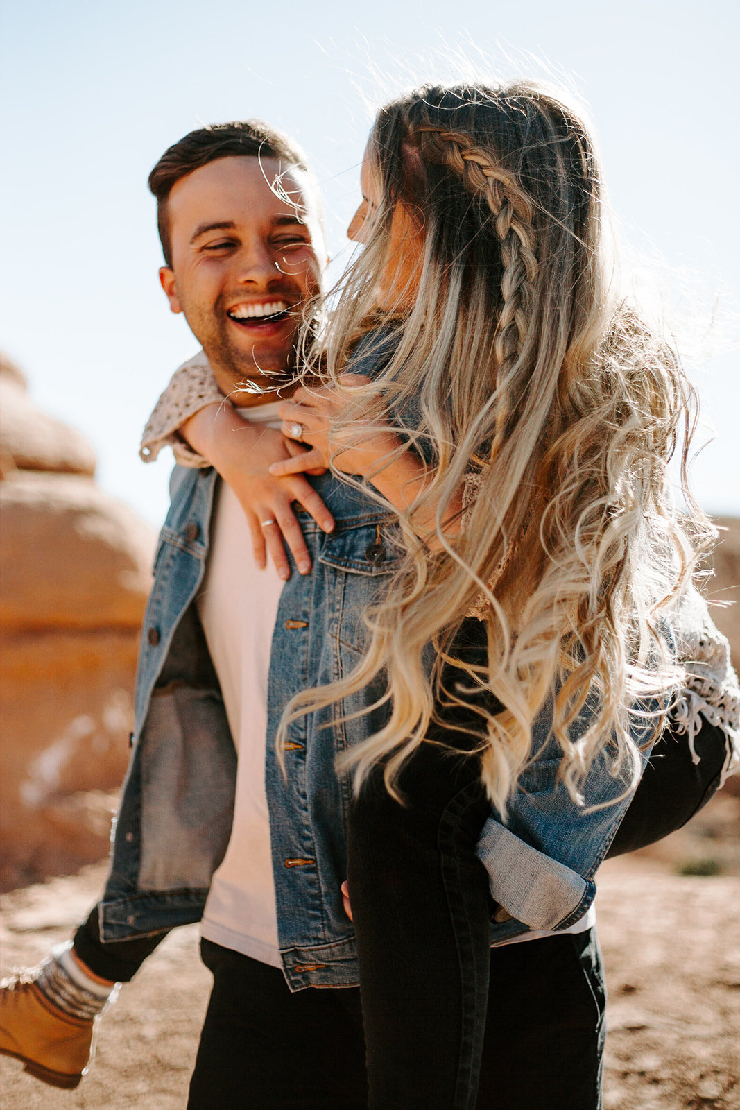 Couple doing a piggy back ride during their Arizona engagement session
