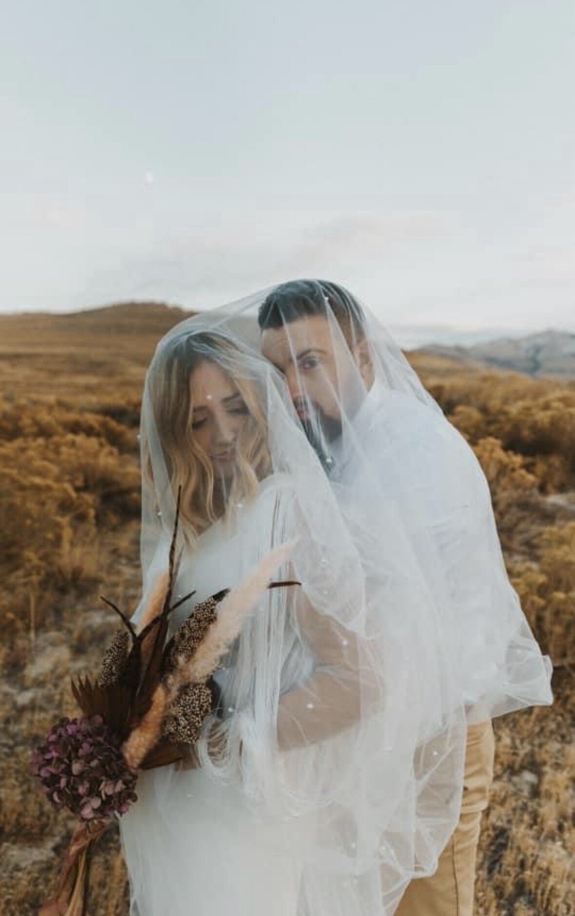 Boho fall wedding photo of bride and groom