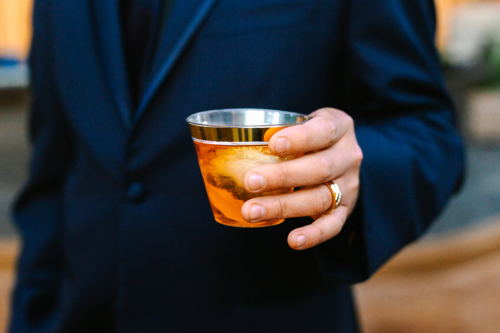 Wedding cocktail held by the groom.
