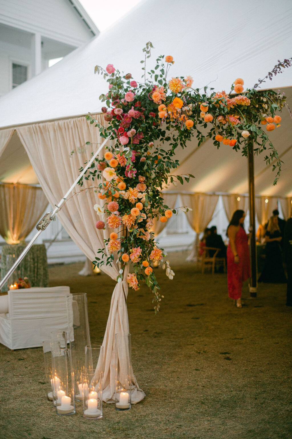 Florals and candles at tented Wedding reception at Lyceum Lawn