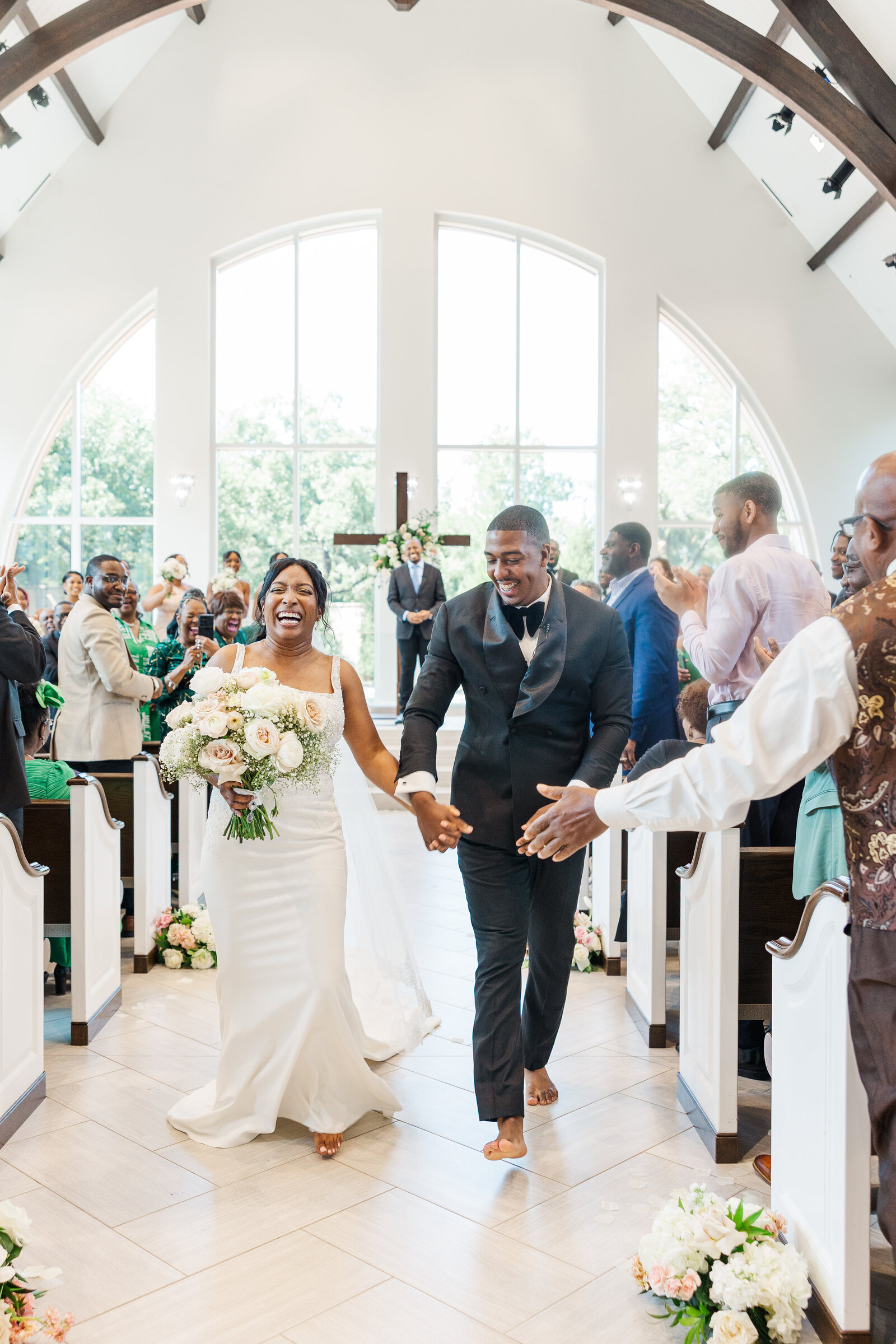 Bride and groom walk down the aisle after wedding ceremony