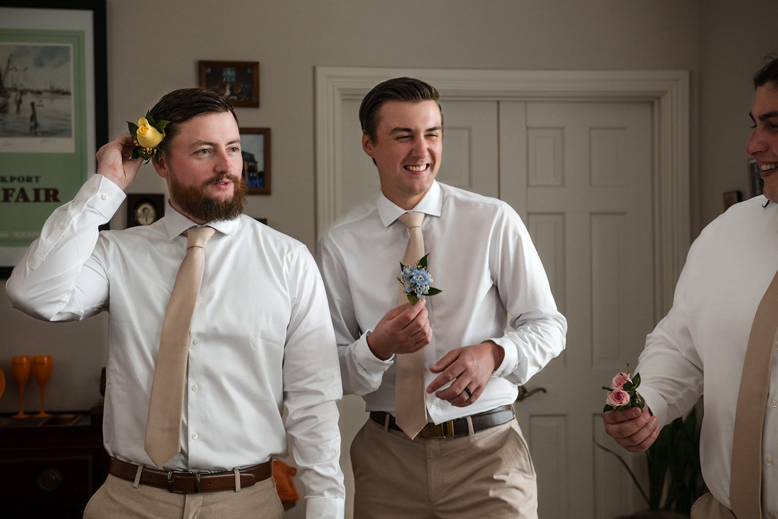 The groom and best man sharing a light-hearted moment as they prepare for the wedding ceremony, captured by CMH Studios in San Antonio.