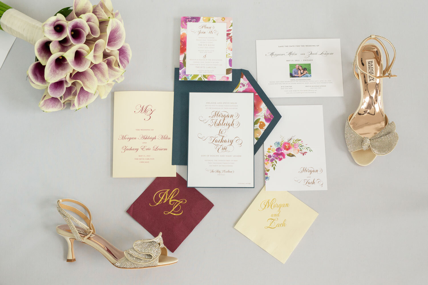 A bouquet of flowers sits on a table next to wedding invitations