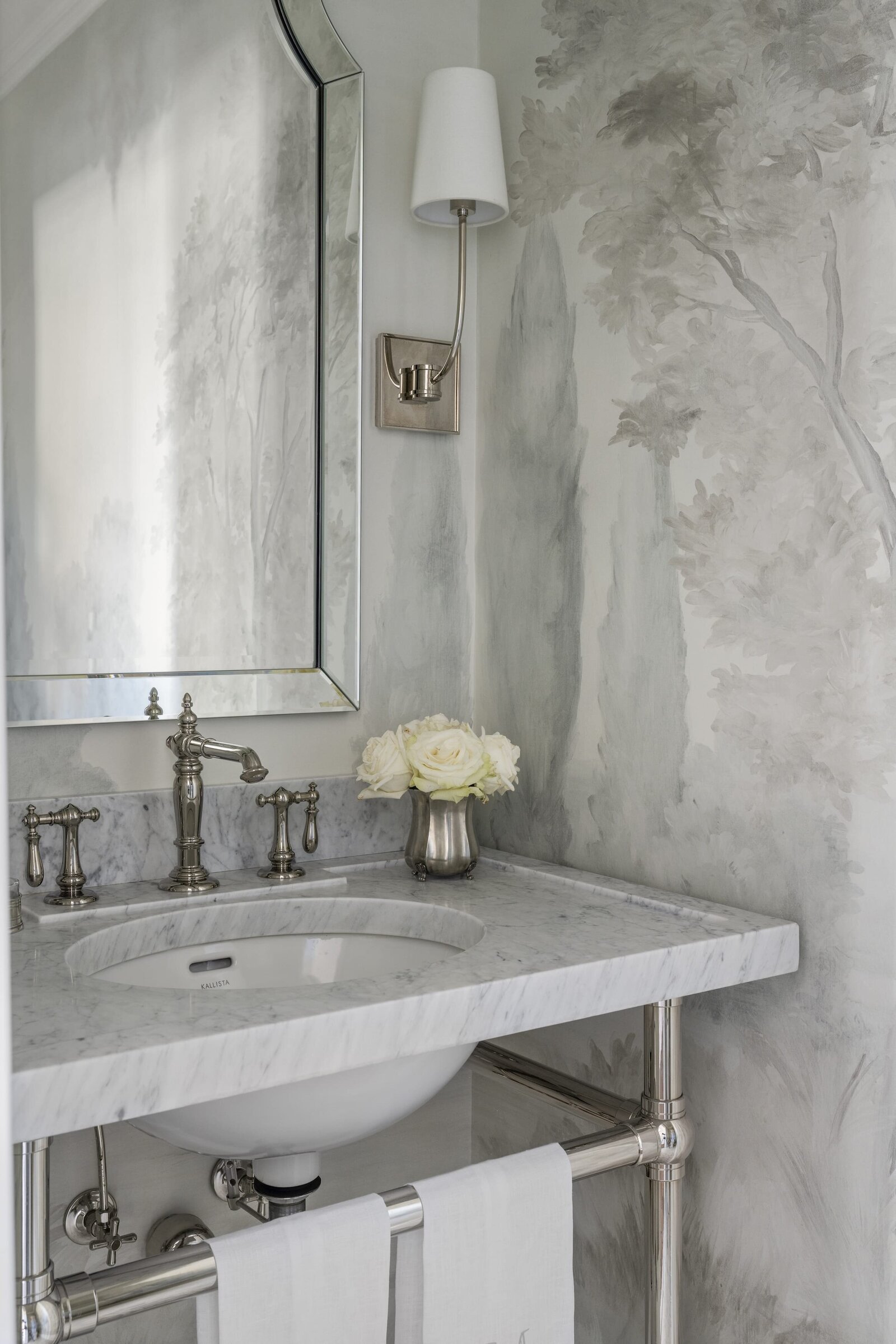 candra lynn interiors ocean port project bathroom sink with white roses on counter and silver finishes