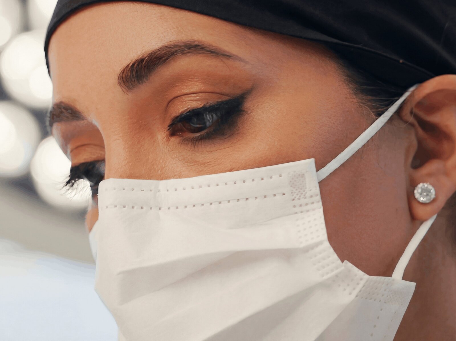Close-up of a surgeon’s eyes above a surgical mask