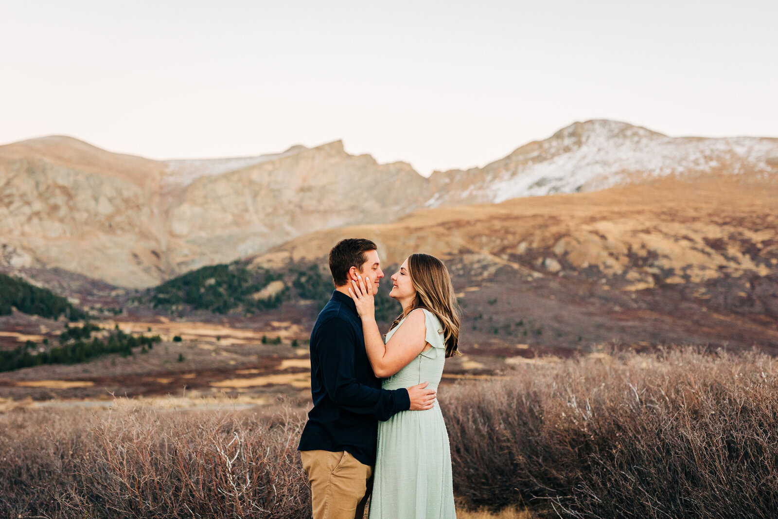 Denver Wedding Photographer captures woman embracing man during outdoor engagement photos