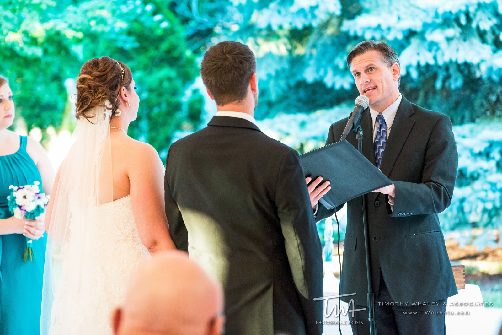 Bride and groom hold hands during wedding ceremony