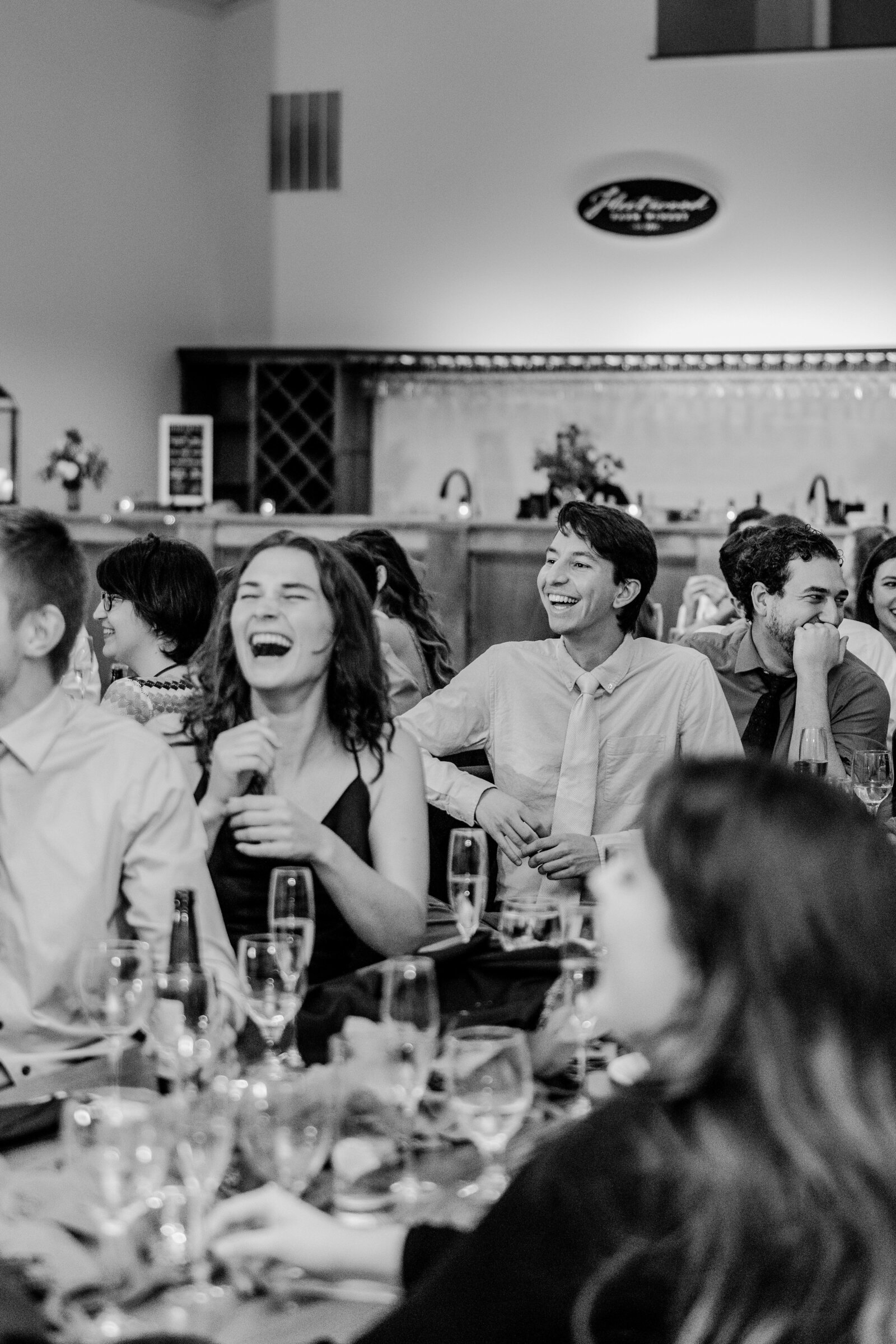 Wedding guests laughing at their tables during a wedding at Fleetwood Farm Winery in Leesburg Virginia