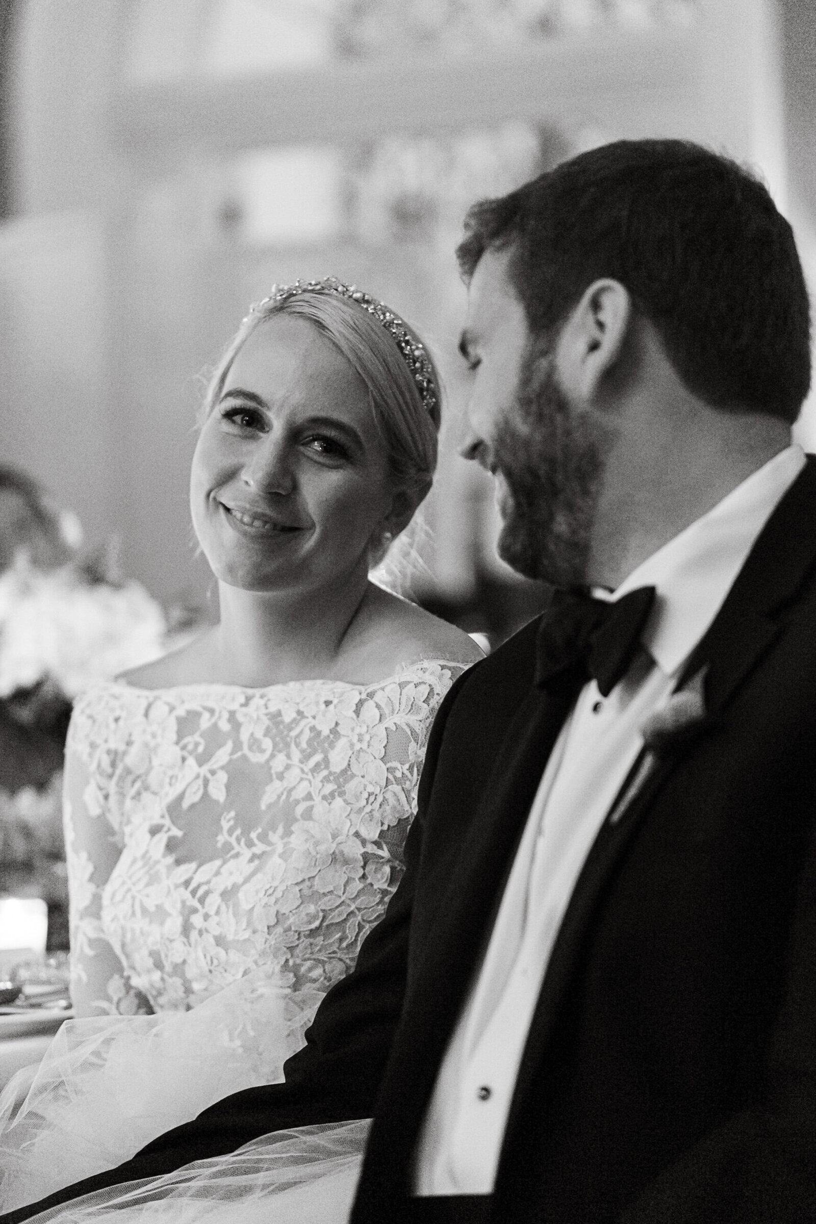 Groom looking tenderly at his wife.