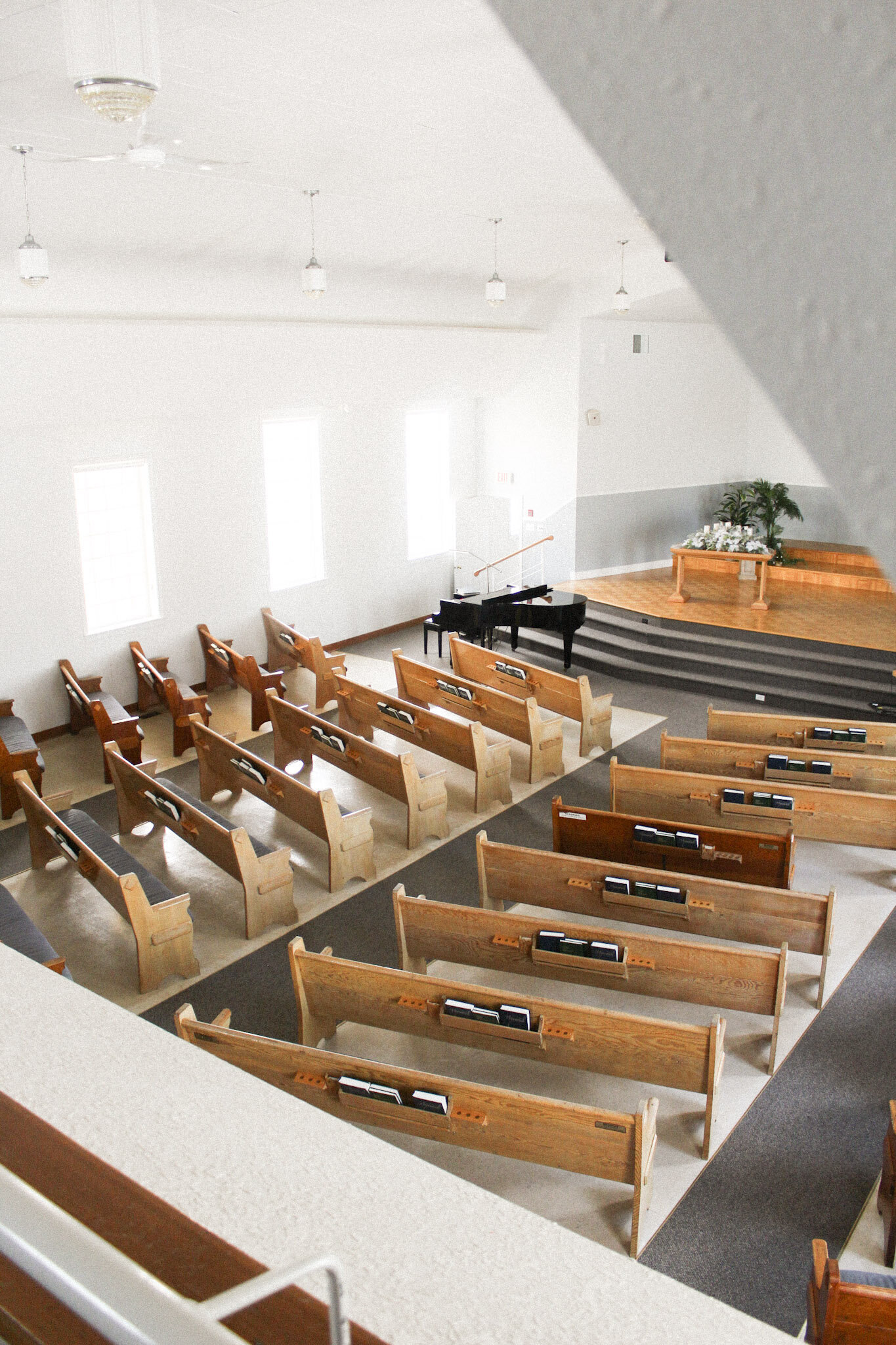 Beautifully decorated indoor chapel at Bergthal Event Centre, featuring elegant wooden pews and a stunning vaulted ceiling for wedding ceremonies