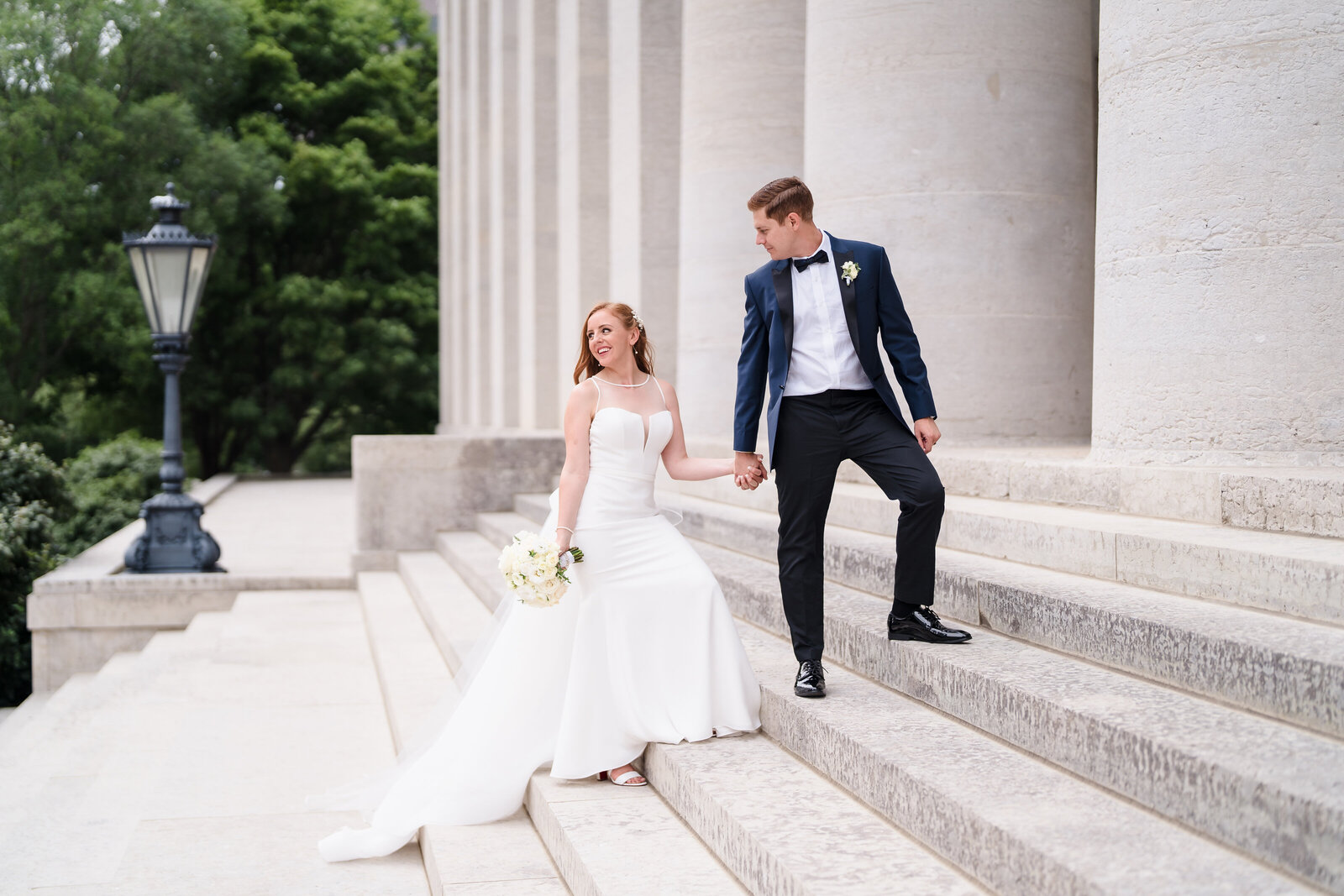 A groom leads his bride up the steps of the Ohio Statehouse in downtown Columbus