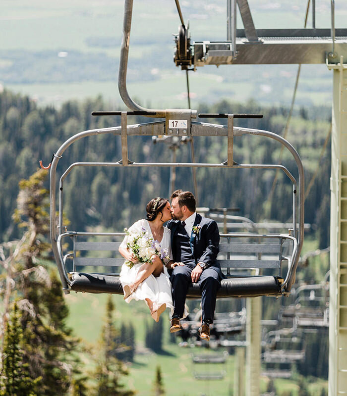 A couple rides a chairlift after their mountaintop elopement at Grand Targhee photographed by Washington elopement photographer Amy Galbraith