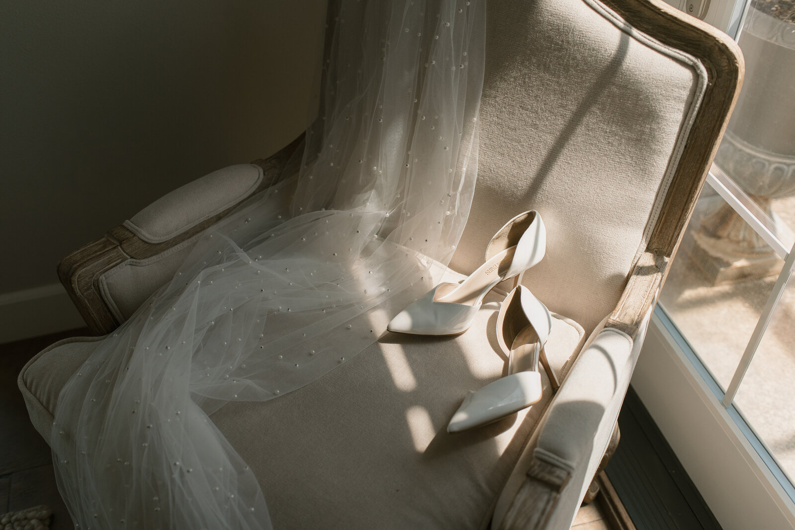 wedding stilettos on a chair with harsh lighting