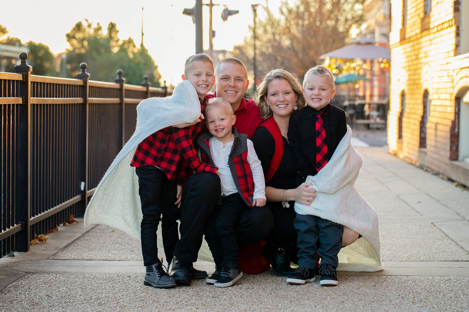 A family of five snuggling under a blanket together during a Northern Virginia family photo session.
