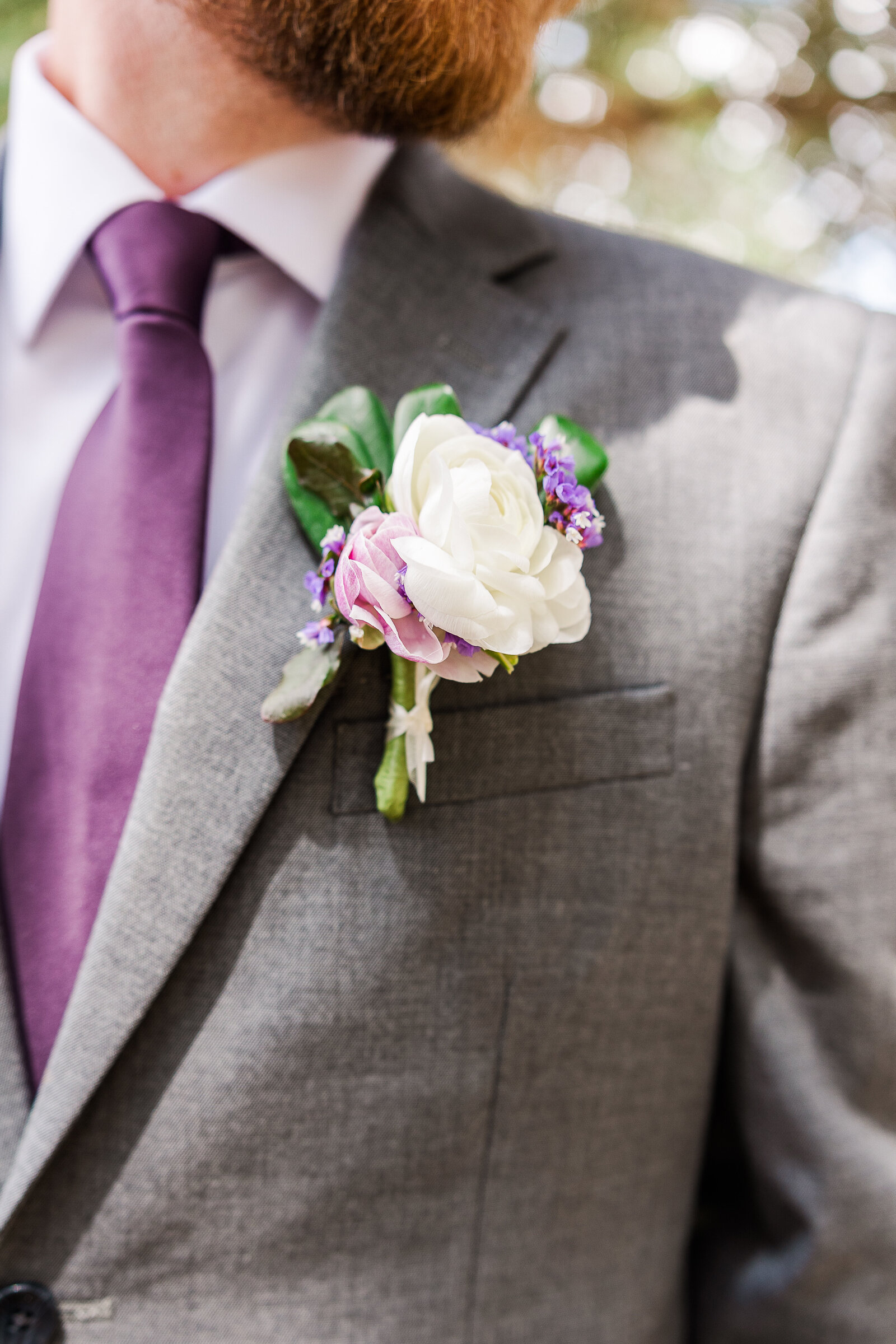Elegant close-up of the groom’s boutonniere featuring fresh florals and greenery at a Ridgway State Park wedding