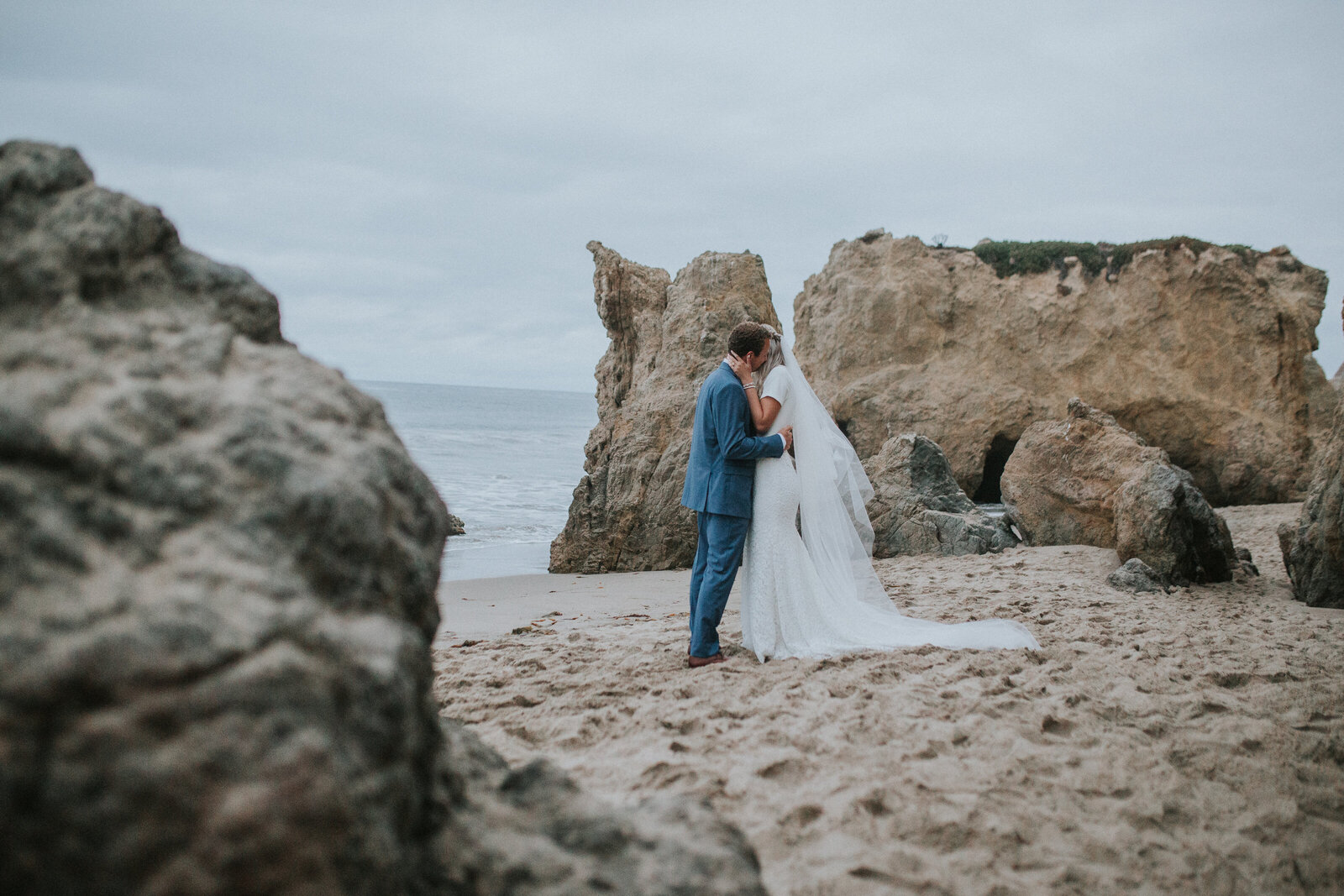 Sacramento Wedding Photographer captures bride and groom hugging on beach at Big Sur