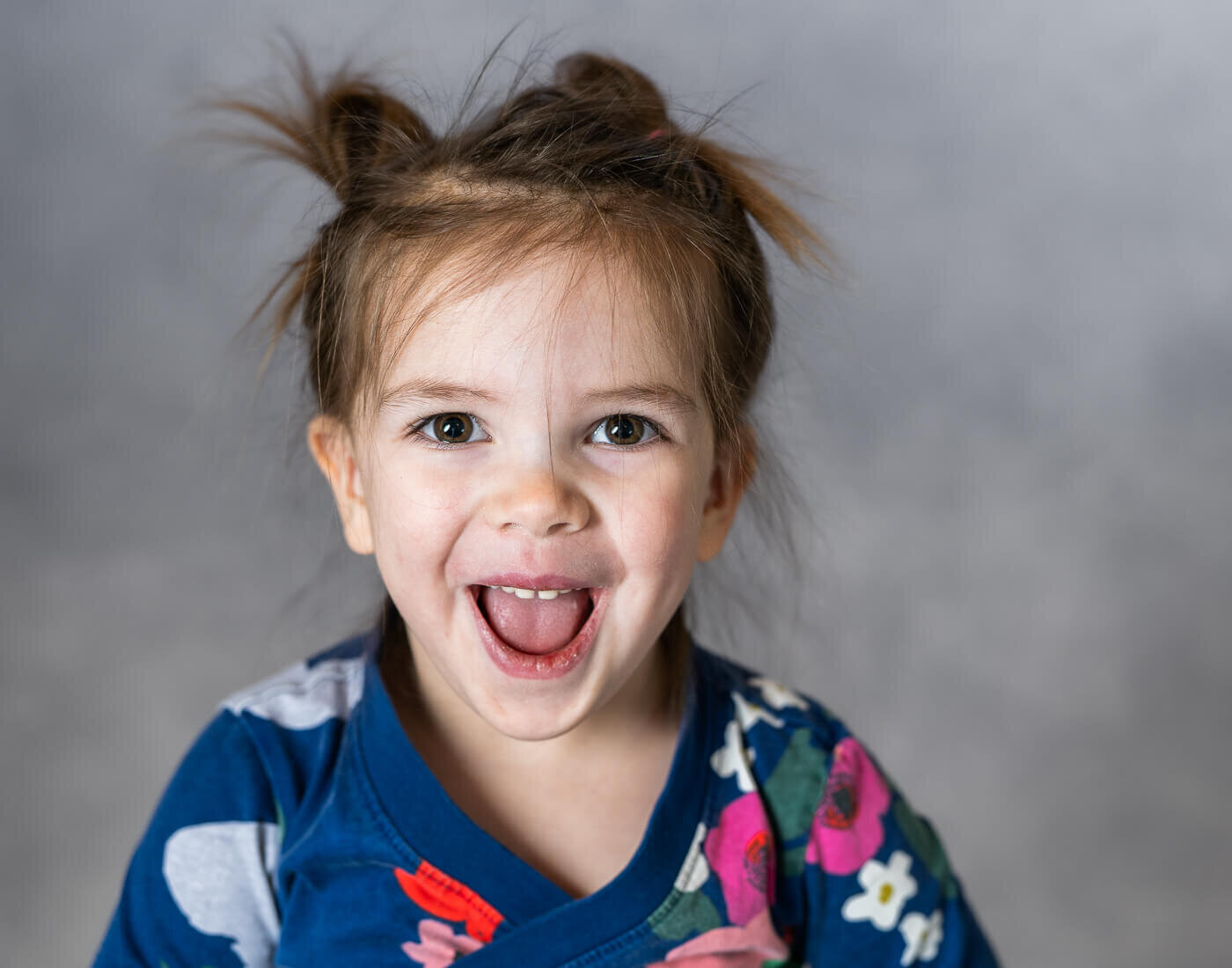 A child smiles gleefully.