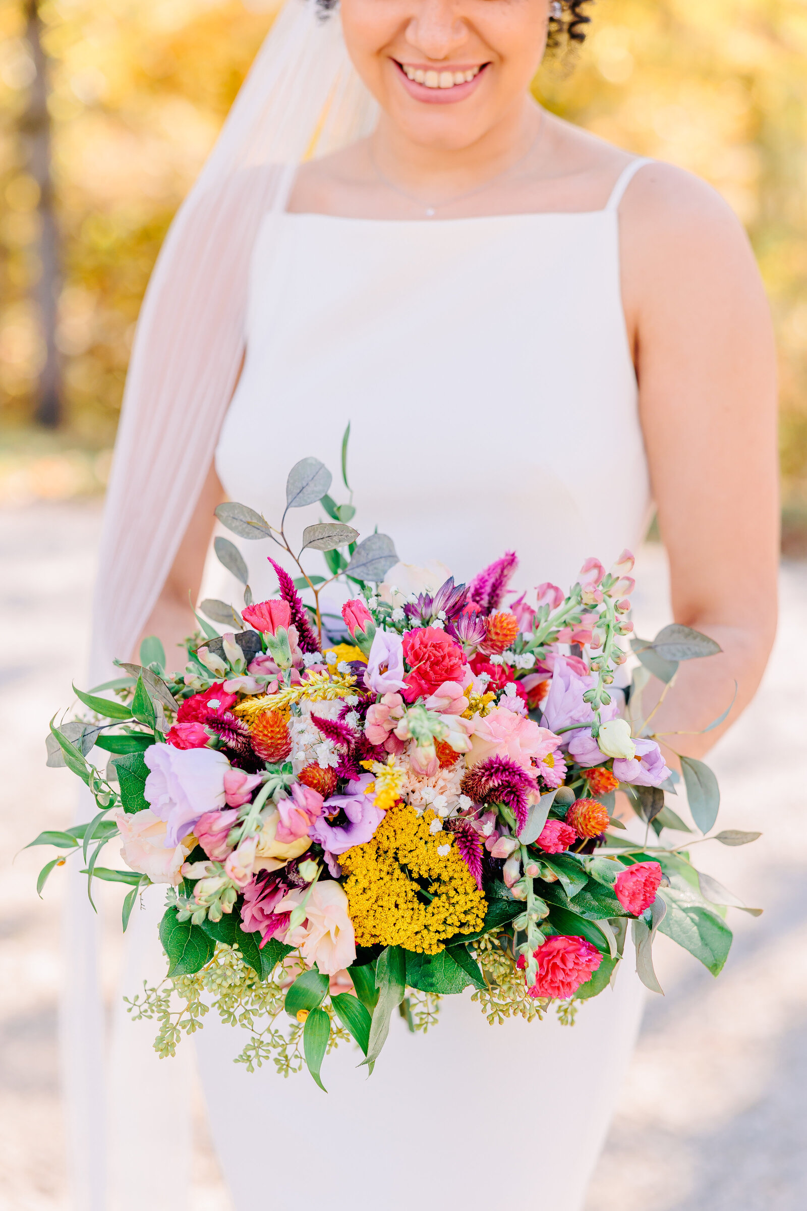 A detail photo of the white and pink blooms in a spring wedding bouquet.