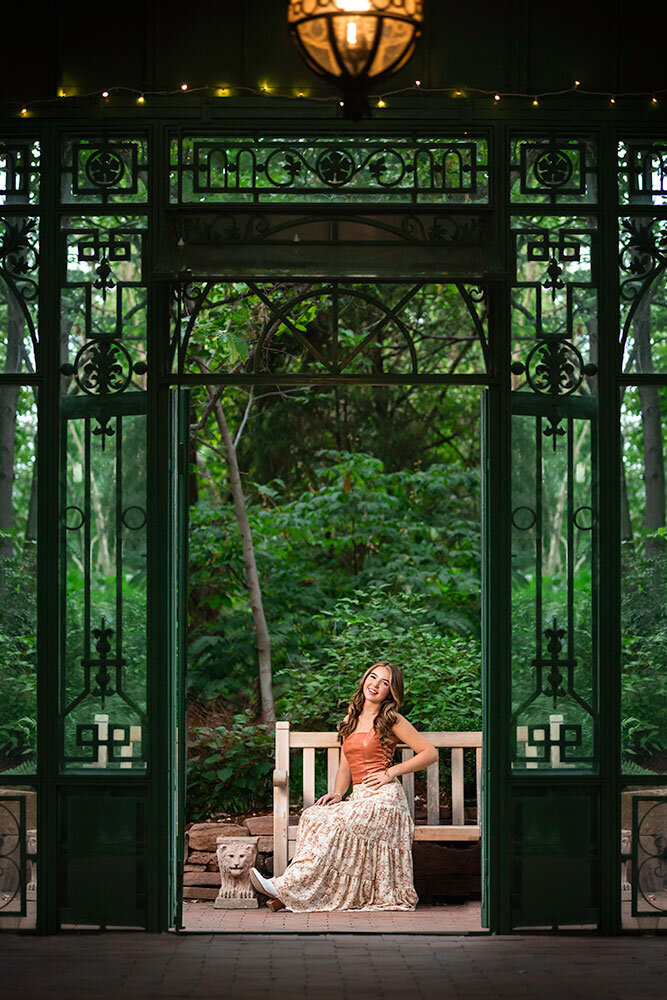 orangery-glass-gazebo-french-denver-botanical-garden-senior-posing-on-bench