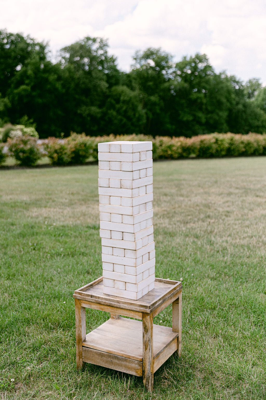 outdoor jenga stacked and ready to play on a small wood table at Windridge Estate