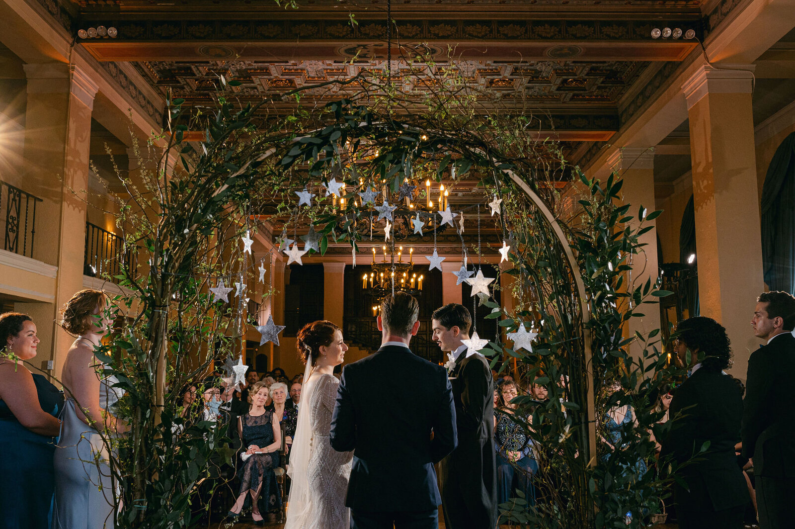 Wedding ceremony at The Ebell of Los Angeles with elegant floral arch and historic architecture, planned by Jasper & Lane Events