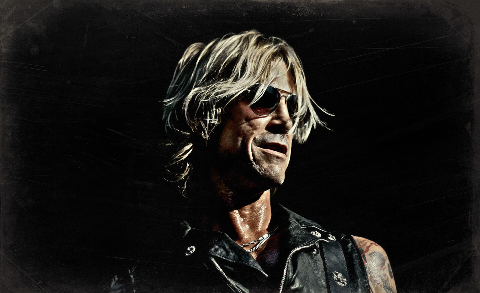 Music portrait Duff McKagan  close up wearing black leather vest