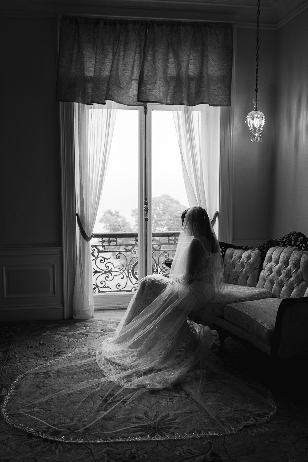bride sit in window with long veil