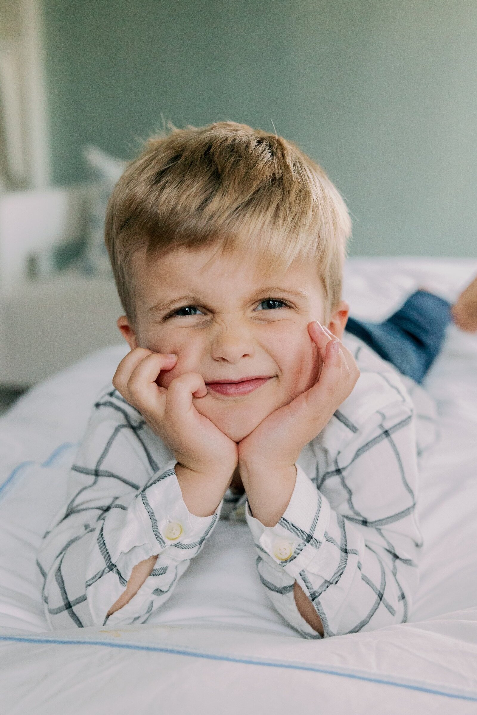 boy making face at camera on bed