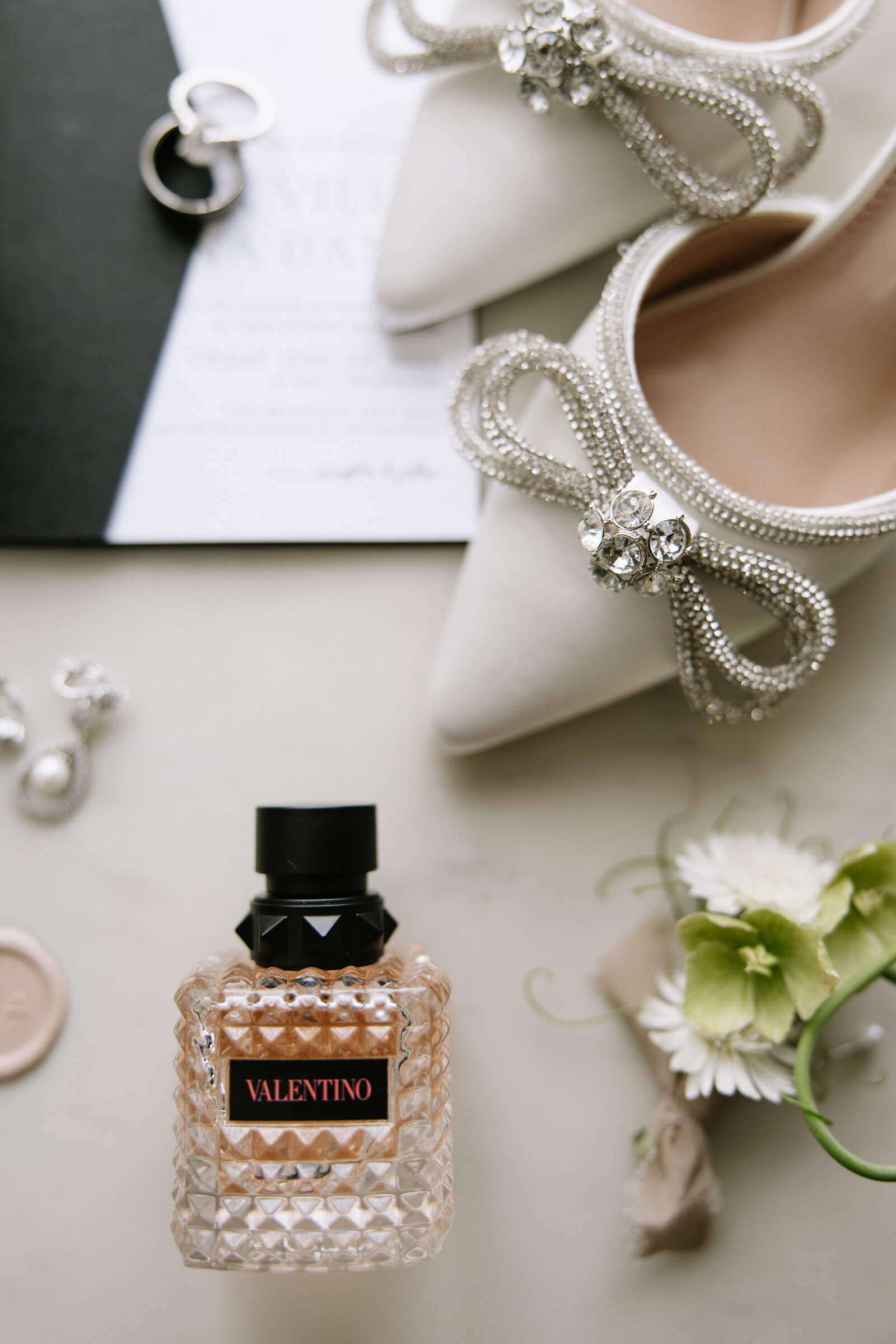 Details of perfume, jewelry, and shoes before San Francisco City Hall wedding