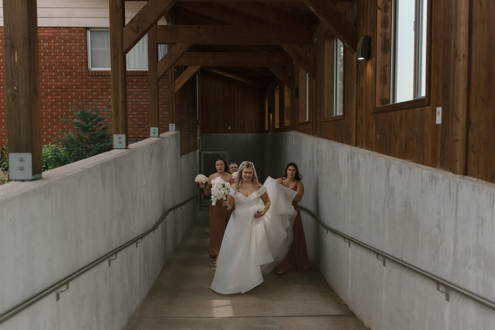 bridesmaids helping the bride with her dress