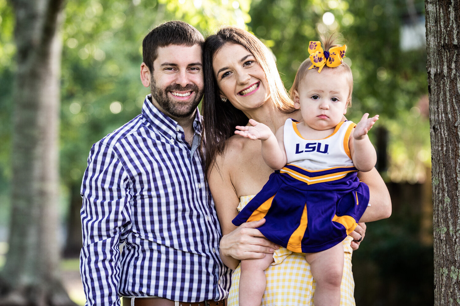 Slidell family portrait with little girl wearing LSU cheerleader dress