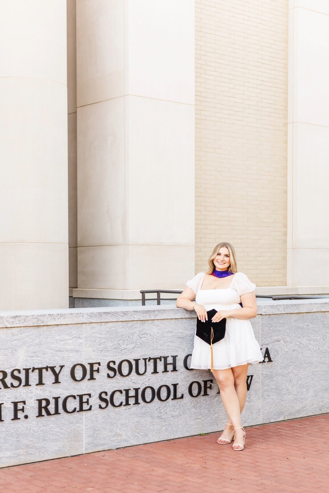 Girl smiling holding graduation cap