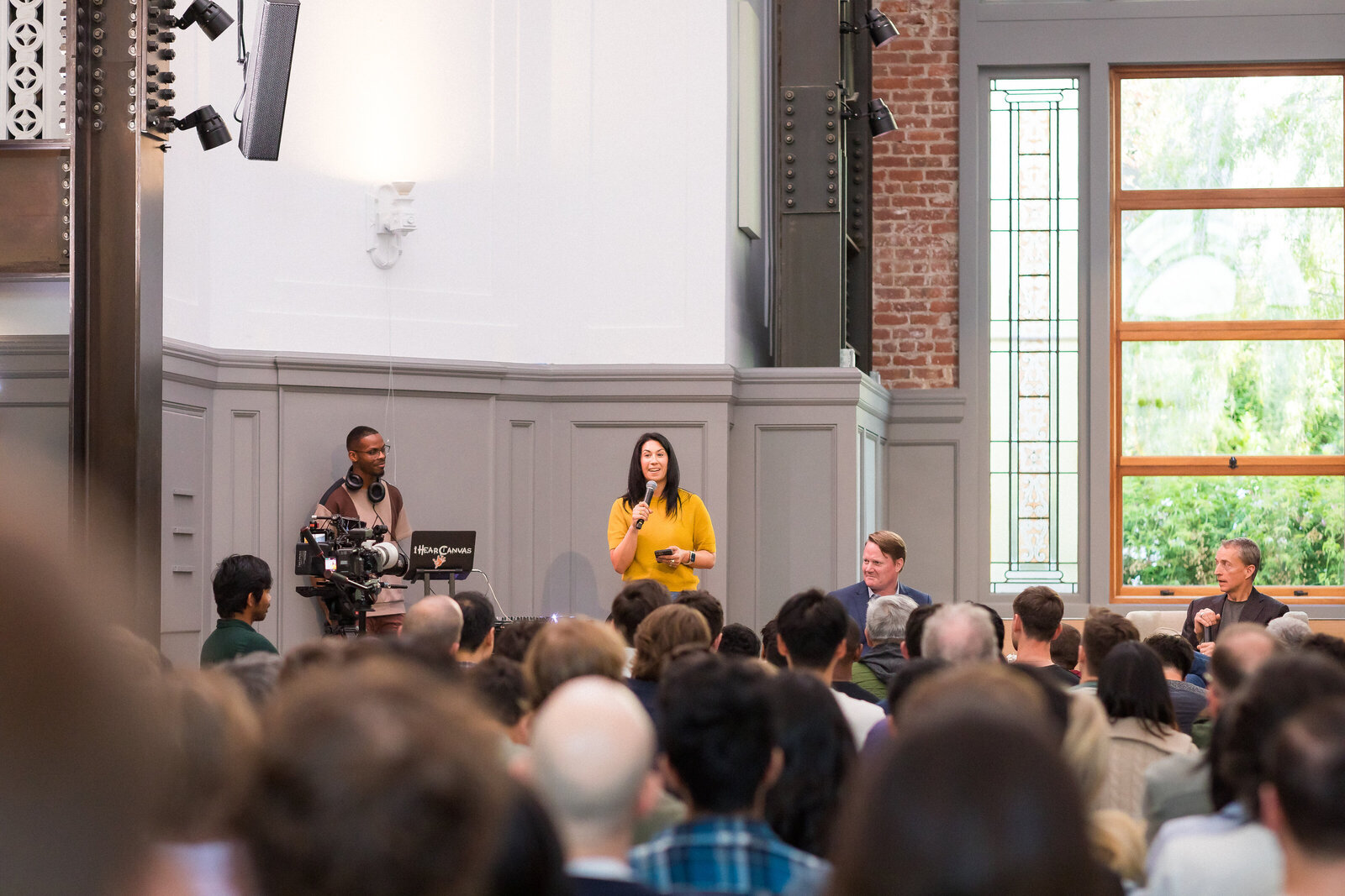 Wide shot of the Holy Shift event with guests listening to the keynote.