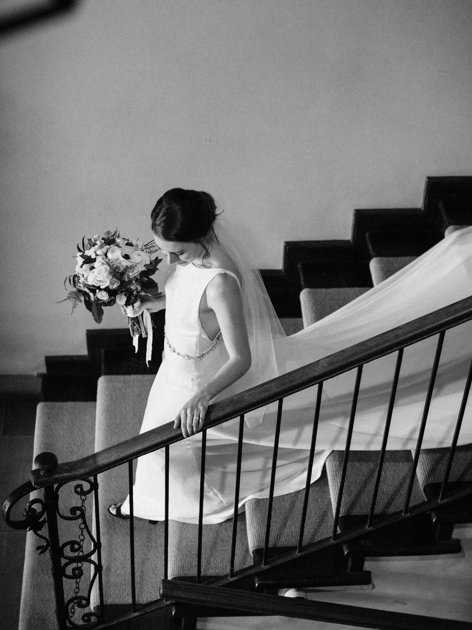 bride walking down stairs at cleveland mansion wedding