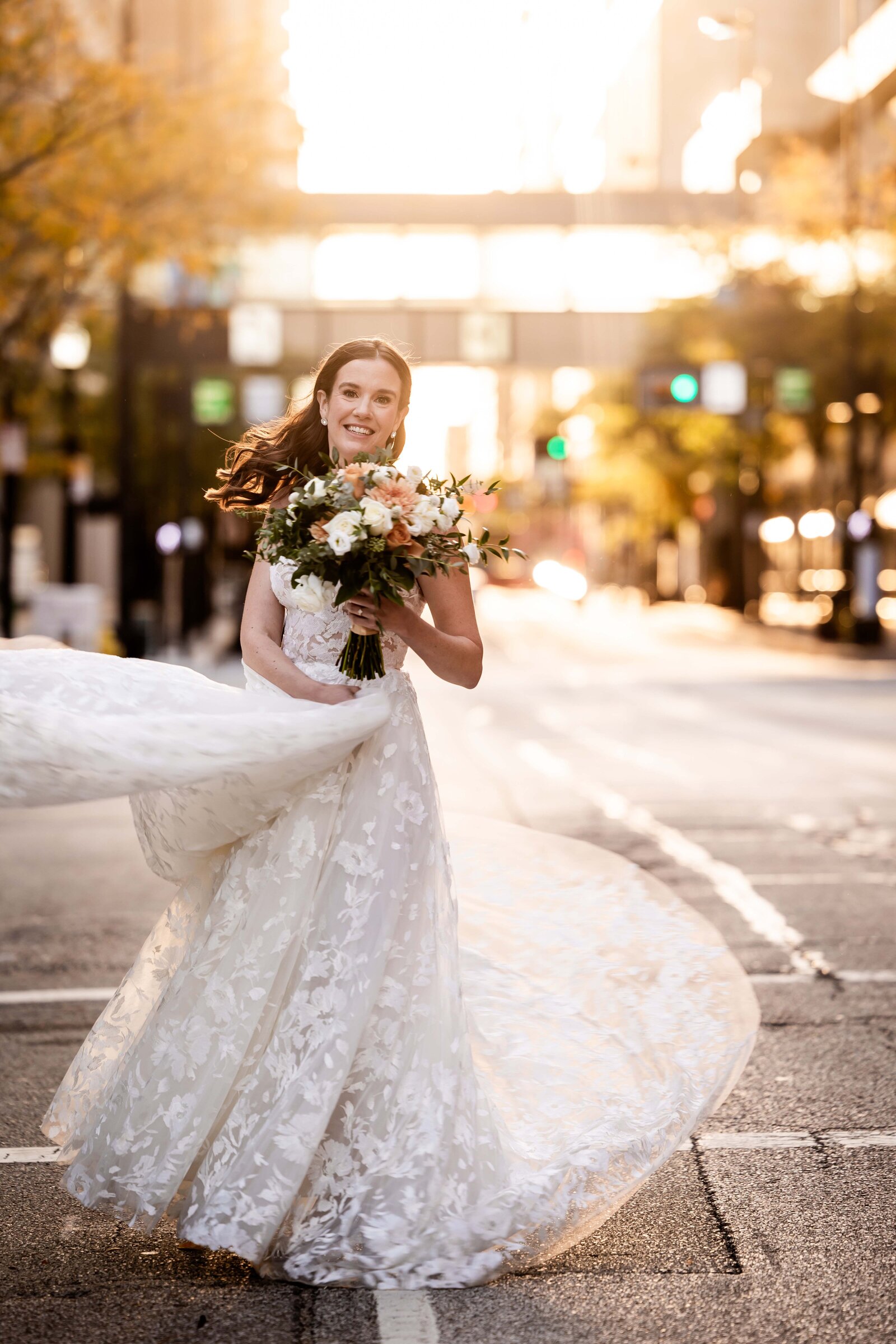 Experience the dynamic beauty of Brooke as she twirls through the streets of Downtown Cincinnati, her dress flowing with stunning movement. This captivating image captures the joy and freedom of her dance, set against the urban backdrop of the city's vibrant streets. Ideal for those seeking unique wedding photography ideas that incorporate dramatic dress movement and urban charm, this photo demonstrates how a bride can truly shine in a non-traditional setting.